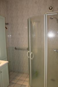 a shower with a glass door in a bathroom at Maison LC in Cramant +10 photos