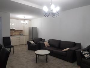 a living room with a couch and a table at Cottage Panorama in Bakuriani