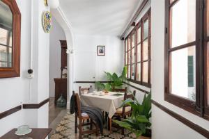 a dining room with a table and some windows at Hostal Pons in Palma de Mallorca