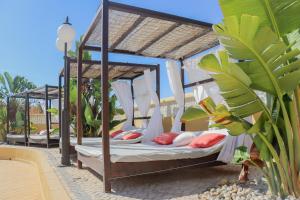 two beds in a canopy bed on a patio at Quinta Nova Vale Del Rey in Carvoeiro