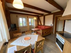 a kitchen and living room with a table and chairs at Haus Gamrigblick in Waltersdorf