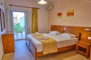 a bedroom with a bed with two towels on it at Beachside Bungalows Acharavi Corfu in Acharavi