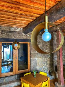 a dining room with a wooden table with yellow chairs at Zocailla in Gata +26 photos