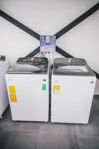 two white refrigerators sitting next to each other at APARTASUITES 21 A in Pereira