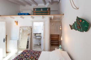 een kamer met een bed en een plank aan de muur bij Valley house Aljezur old town in Aljezur