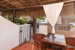 a wooden table and chairs on a balcony with a table at Hotel 1697 Loreto in Loreto