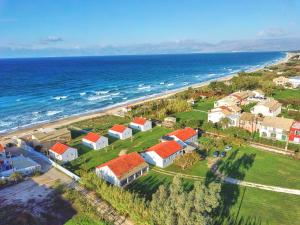an aerial view of a beach with houses and the ocean at Beachside Bungalows Acharavi Corfu in Acharavi