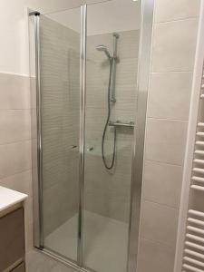 a shower with a glass door in a bathroom at B&B The Secret Place in Cavedago