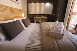 a bedroom with a large bed with a box on it at Mavà in Catania