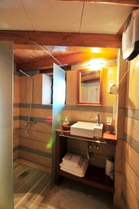 a bathroom with a sink and a shower at Izambo Guest Houses in Monemvasia