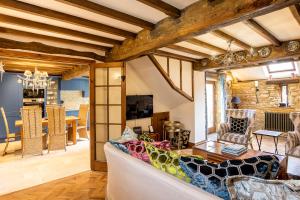 a living room with a couch and a table at Granary Cottage - Luxury Barn Conversion in Weston Subedge