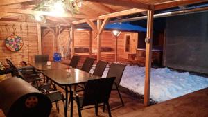 a table and chairs in a room with snow at UBYTOVÁNÍ S WELLNESS in Dolní Dobrouč