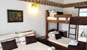 a room with three bunk beds in a room at Hotel Boutique La Española in Villa de Leyva