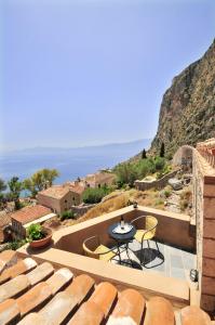a view of a patio with a table and chairs at Izambo Guest Houses in Monemvasia