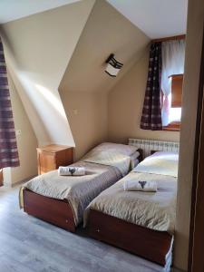 a bedroom with two beds in a attic at Pod Tatrami in Bukowina Tatrzańska