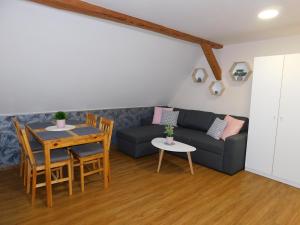 a living room with a couch and a table at Apartmány Brychovi in Červený Potok