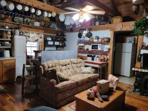 a living room with a couch and a kitchen at Mountain Memories Cabin Rental in Booneville