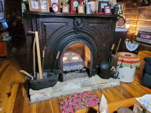 an old woodburning fireplace in a living room at Mountain Memories Cabin Rental in Booneville