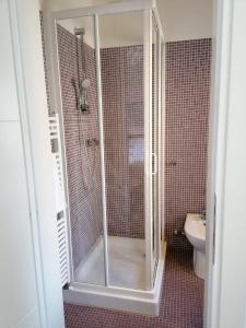 a bathroom with a shower with a toilet and a sink at Poggetto home in Florence