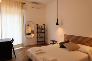 a bedroom with a large bed and a mirror at B&B Casa Valentina in Rome +70 photos