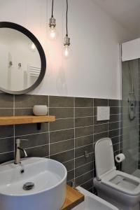 a bathroom with a sink and a toilet and a mirror at B&B Casa Valentina in Rome