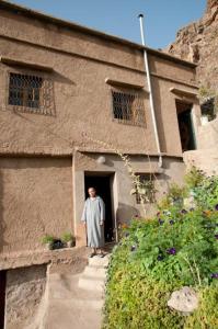 a man standing in the doorway of a building at Gite Panorama in Imlil