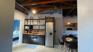 a kitchen with a refrigerator and a table in a room at MySA in Durban
