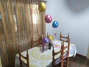 una habitación con una mesa con globos en la pared en Villa Amada a place to relax and take a rest, en Loja
