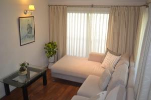 a living room with a white couch and a table at Casa Simona Villa General Belgrano in Villa General Belgrano +57 photos