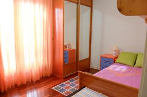 a bedroom with a bed and a dresser and a mirror at Apartamento céntrico, parking gratis in Santander