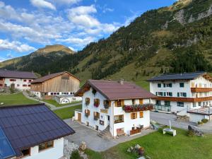a group of buildings with a mountain in the background at Lech Hostel in Lech am Arlberg