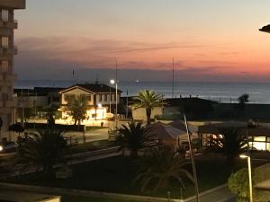 a view of the ocean at sunset from a building at my happy place in Lido di Camaiore