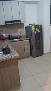 a kitchen with a refrigerator and a sink in it at Apartamento Girardot Espectacular Vista!! in Girardot