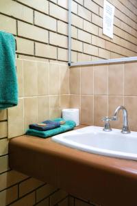 a bathroom with a sink and towels on a counter at Grand Hotel Motel in Clermont