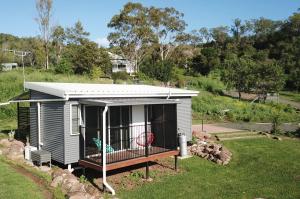 a small house with a deck with a frisbee at Kiambram Country Cottages in Gowrie Little Plain
