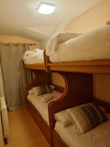 two bunk beds in a room with a ceiling at BUENAVISTA PREMIUM in Sierra Nevada