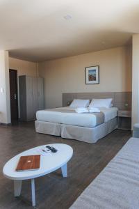 een hotelkamer met 2 bedden en een salontafel bij Solana - Apart Hotel & Club de Tenis in Santa Clara del Mar