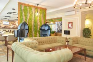 a living room with couches and a table at GREEN Which Hotel in Petropavlovsk