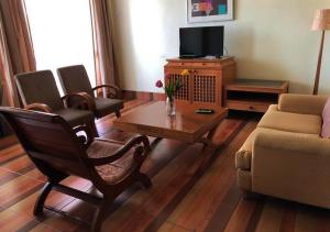 a living room with a couch and a coffee table at 2 room Apartment @ Langkawi Lagoon Resort in Kampung Padang Masirat
