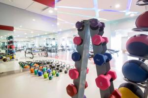 a gym with a bunch of dumbbells and weights at VS Hotel in Manila