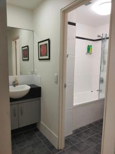 a bathroom with a shower and a sink at Beachfront Beauty! in Mission Beach