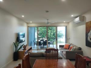 a living room with a couch and a table at Beachfront Beauty! in Mission Beach