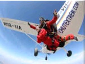 two people on a plane flying in the sky at Les chambres touristique Juléa in Dienville