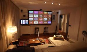 a living room with a large screen in the wall at George Apartment in Neuilly in Neuilly-sur-Seine