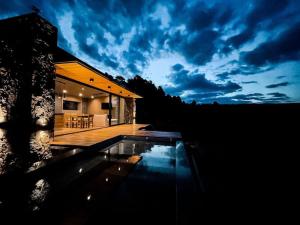 a house with a swimming pool in front of it at Cabaña La Alemana in Villa Berna