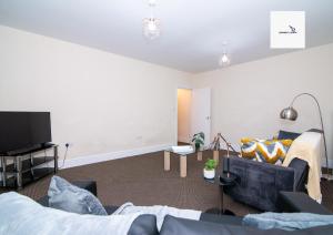 a living room with a couch and a tv at 5Blythe House Apartments Brierley Hill in Birmingham