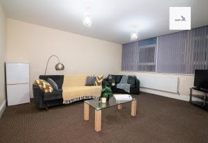 a living room with a couch and a coffee table at 5Blythe House Apartments Brierley Hill in Birmingham
