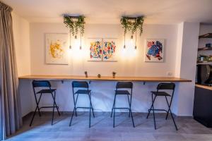 a bar in a kitchen with four stools at Il Gelso Guest House in Catanzaro
