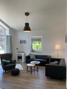 a living room with a couch and a table at Bauernhof Hopp in Vadersdorf