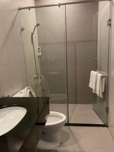 a bathroom with a toilet and a glass shower at Song Tra Hotel in Xóm Phước Mỹ +18 photos